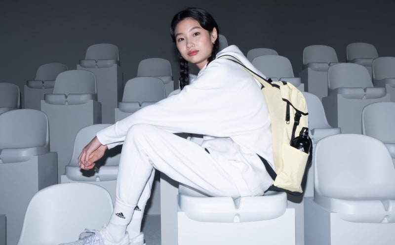 Female model wears Z.N.E. Sportswear backpack.