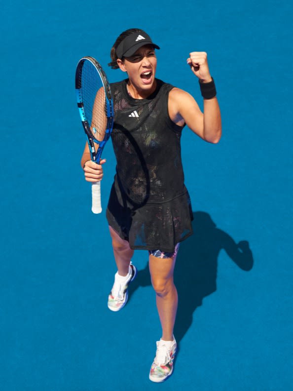 Female tennis player holding a fist in victory