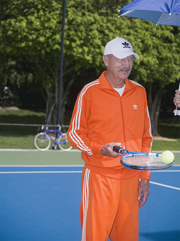 Stan holding a tennis racket dressed in adidas.