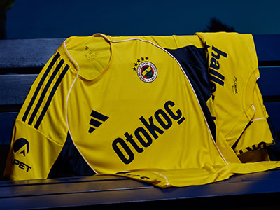 A yellow and black soccer jersey with the word "Otokoc" prominently displayed, set against a dark blue background.