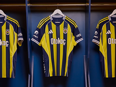 The image shows several yellow and black soccer jerseys hanging on a rack, with the Otokoc logo prominently displayed on the front of each jersey. The jerseys appear to be part of a team's uniform, and the background suggests they are displayed in a locker room or similar sports-related setting.
