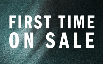 The image displays the text "FIRST TIME ON SALE" in large, bold letters against a dark green or teal background.