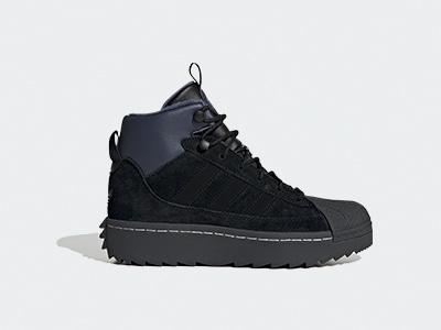 A black, rugged-looking boot with a thick sole and laces, set against a plain white background.