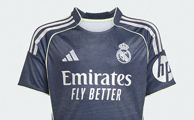 A dark-colored soccer jersey with the Real Madrid logo and the "Emirates Fly Better" text prominently displayed.