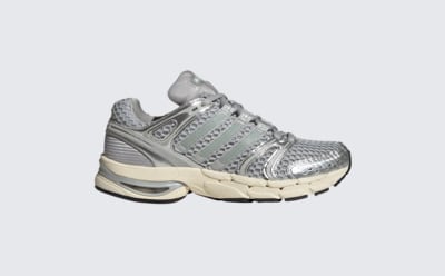 A pair of gray and white athletic shoes with a distinctive design and cushioned sole, set against a plain background.