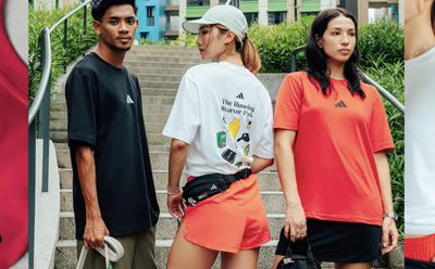 The image shows three young people standing in an urban setting, with one person wearing a white t-shirt, another in a black dress, and the third in a bright orange top.