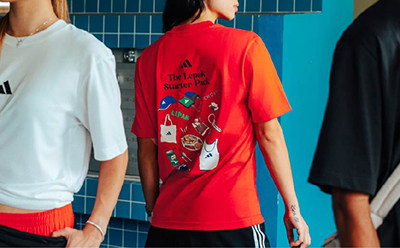 The image shows a group of people wearing various t-shirts, including a bright red one with a graphic design on the back.