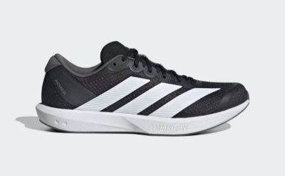 A black and white athletic shoe with a sleek, modern design sits against a plain white background.
