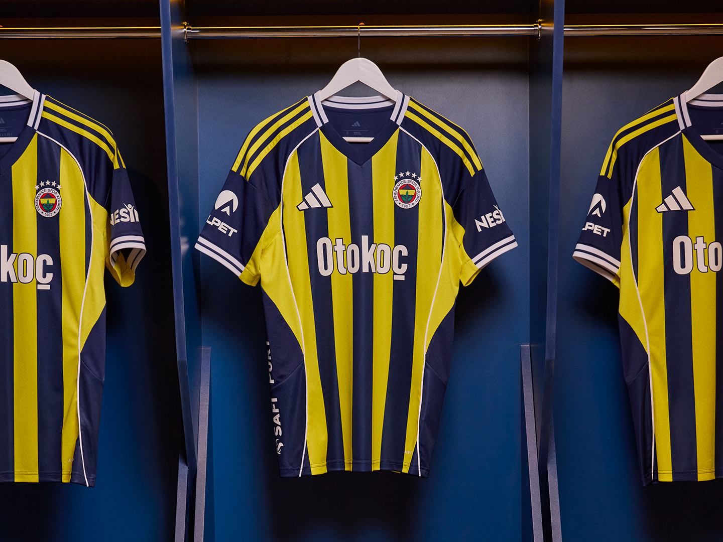 The image shows several yellow and black soccer jerseys hanging on a rack, with the Otokoc logo prominently displayed on the front of each jersey. The jerseys are displayed against a dark background, creating a visually striking contrast.