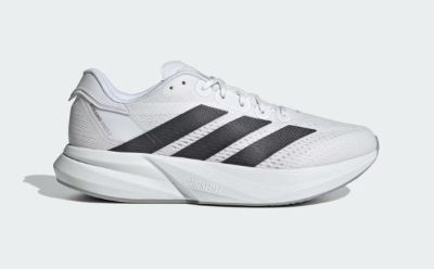 A pair of white and black athletic shoes with a thick, curved sole is displayed against a plain white background.