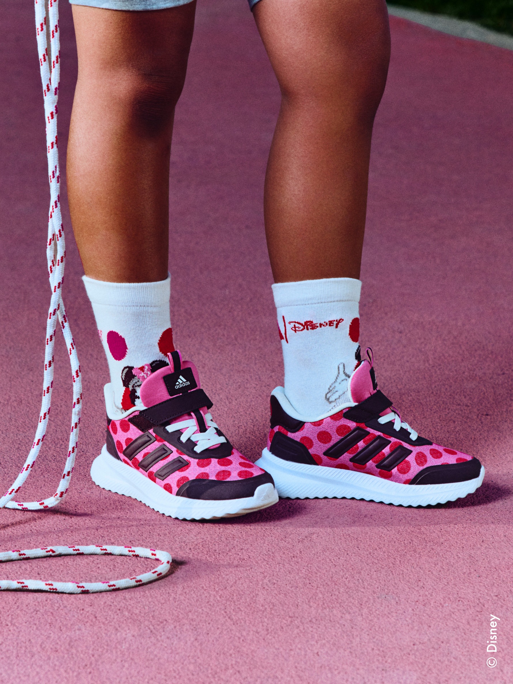 Close up of child’s footwear and skipping rope, wearing the adidas | Minnie collection