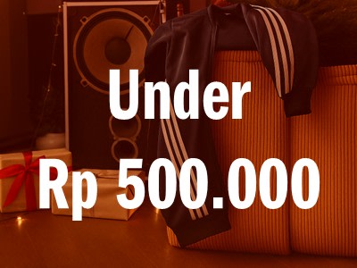 The image shows a sign displaying the text "Under Rp 500.000" against a background of what appears to be audio equipment or speakers.