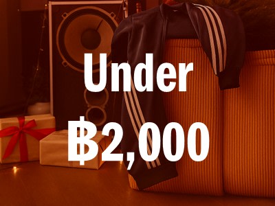 The image shows a sign that reads "Under $2,000" in large text, with a gift box and audio equipment visible in the background.