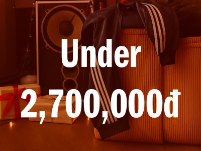 The image shows a large price tag displaying the text "Under 2,700,000d" against a background of what appears to be audio equipment or speakers.