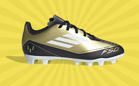 A gold and black athletic shoe with cleats on a yellow radial background.