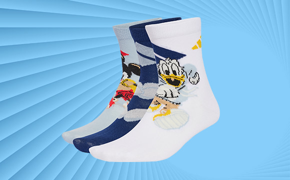 A pair of white socks with a colorful cartoon character design against a vibrant blue background with radiating lines.
