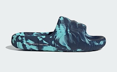 A pair of blue and black patterned clogs or sandals against a plain white background.