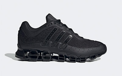 A black athletic shoe with a distinctive sole design and textured upper, set against a plain background.