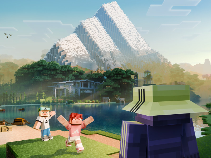 A serene lakeside scene with a pair of blocky, pixelated figures in the foreground, surrounded by lush greenery and towering, crystalline structures in the background against a bright, clear sky.