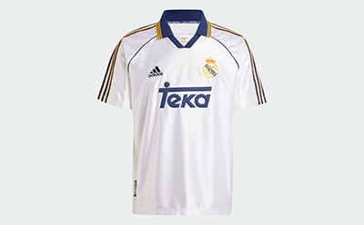 A white and navy blue soccer jersey with the Adidas and Teka logos prominently displayed on a plain white background.