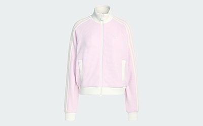 A light pink zip-up jacket or sweater is displayed on a white background.