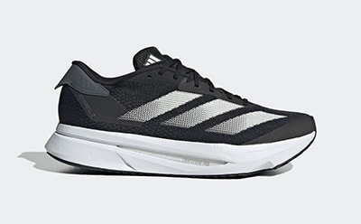 A pair of black and white athletic shoes with thick soles and laces, set against a plain background.