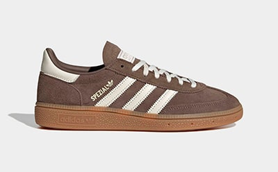 A pair of brown and white Adidas Samba sneakers with a gum sole, set against a plain white background.