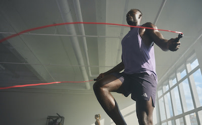 Male lifting weights wearing the adidas strength collection