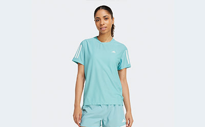 The image shows a person wearing a light blue t-shirt with white stripes on the sleeves, standing against a plain white background.