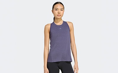 The image shows a young woman wearing a purple athletic tank top against a plain white background.
