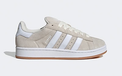 A pair of beige and white sneakers with a gum sole, set against a plain white background.