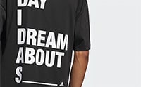 A black t-shirt with the text "I DREAM ABOUT S" printed on it against a plain white background.