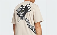 The image shows a beige t-shirt with a large, stylized black fish or shark-like creature printed on the back.