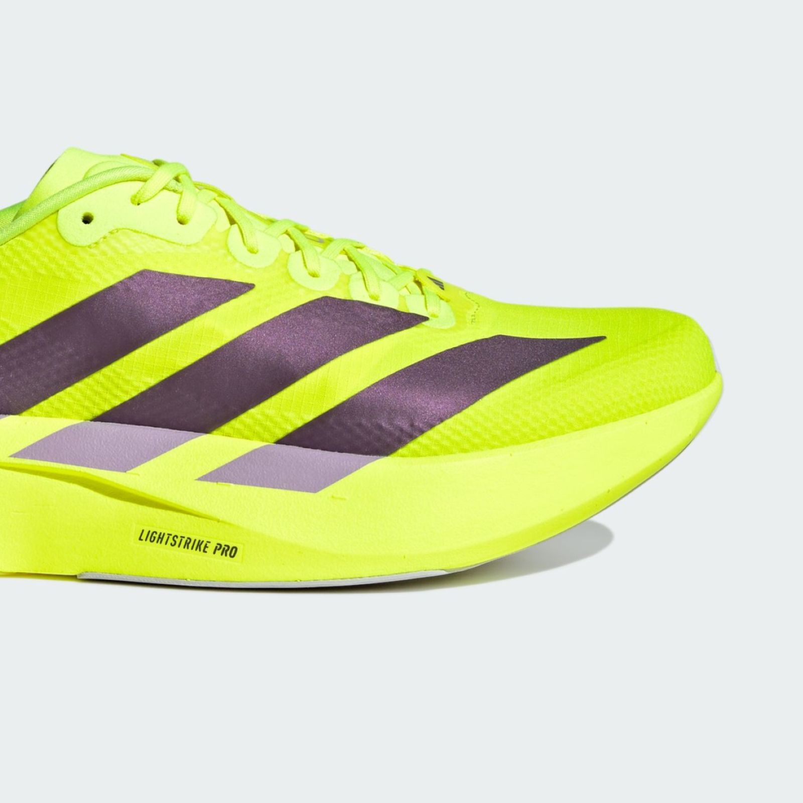 A bright neon yellow athletic shoe with black stripes and accents, set against a plain white background.