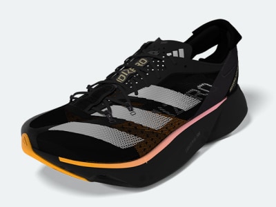 A black and orange athletic shoe with a mesh upper and thick sole, set against a plain white background.