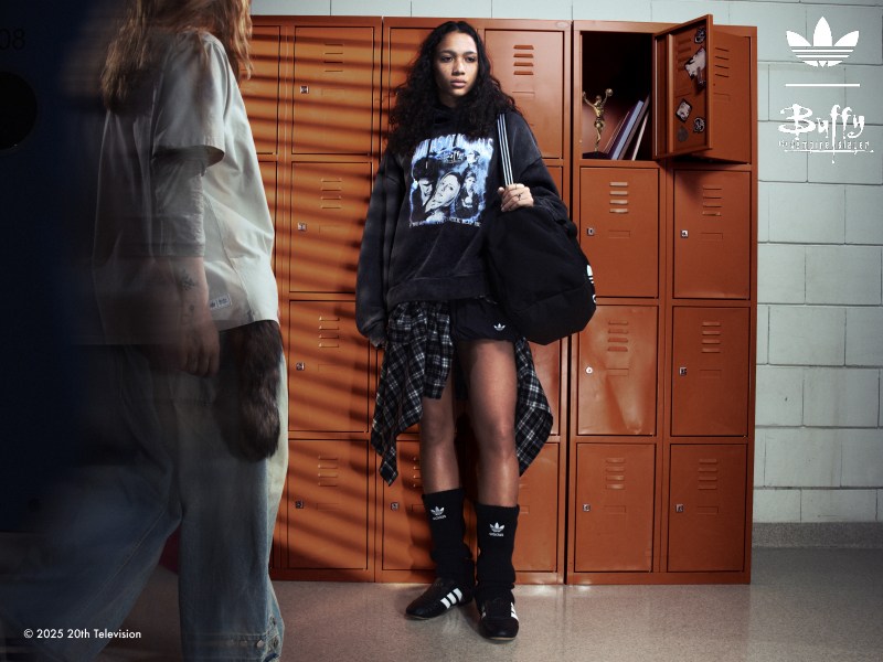 Two young women on a corridor with orange lockers wearing adidas | Buffy the Vampire Slayer collection.