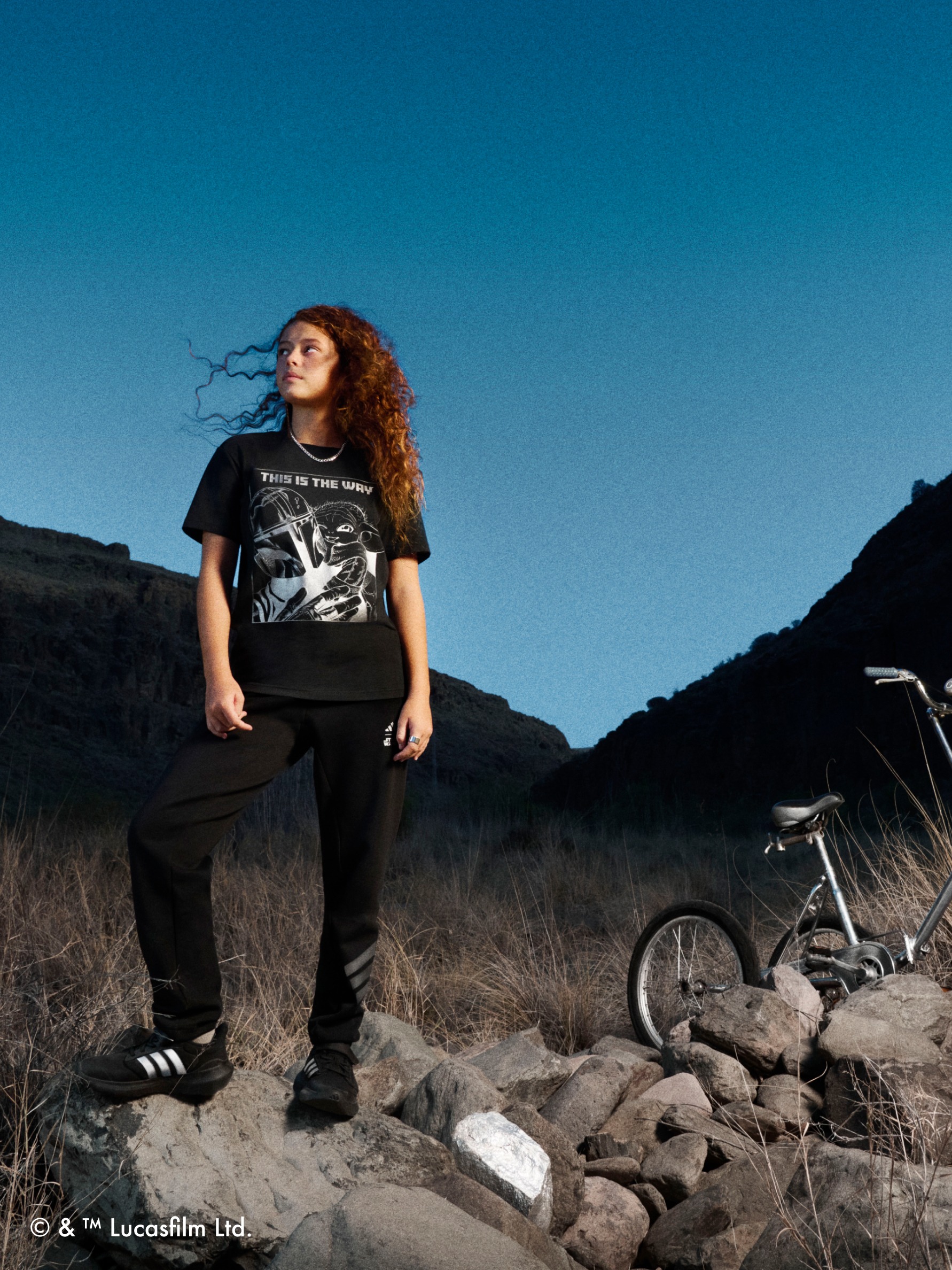 One child standing on a rock wearing the adidas | Star Wars: The Mandalorian™ collection