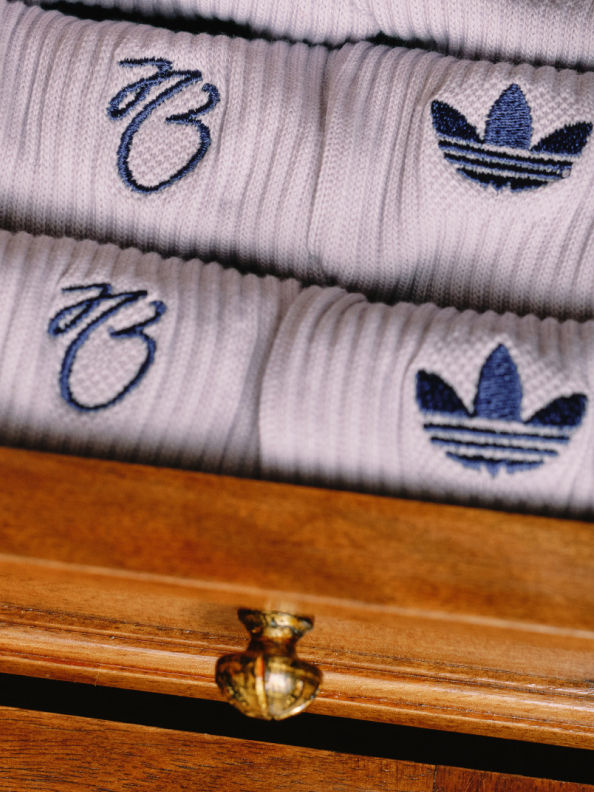 Close-up of white socks from the adidas Bellingham collection, folded with Trefoil and Bellingham logos visible.