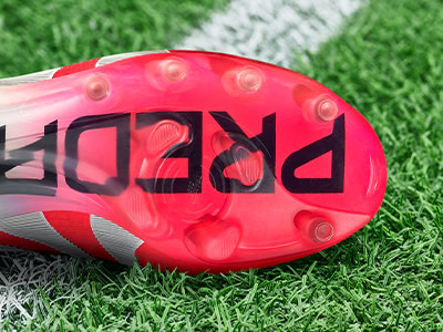 An outsole of an adidas football boot made to be played on artificial grass