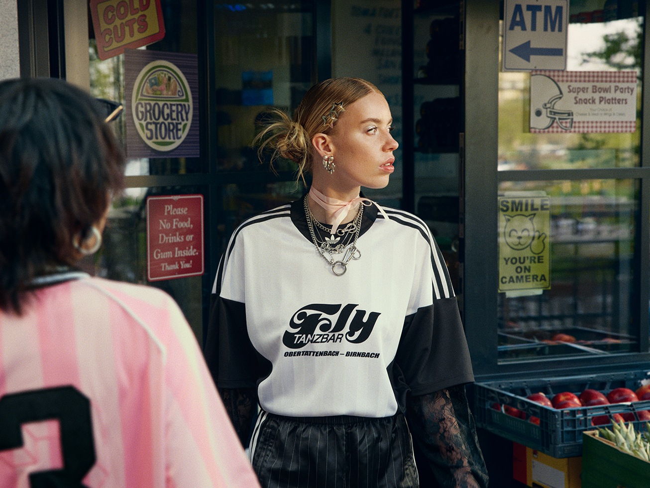 Shot of two adidas models wearing football shirts and soccer jerseys, as well as lace swing skirts and track shorts from the FW25 collection.