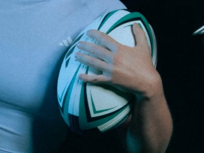 Close up of a rugby player holding a rugby ball