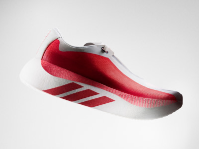 The image shows a close-up view of a pair of sneakers with a distinctive blue and purple color scheme, resting on a dark surface.