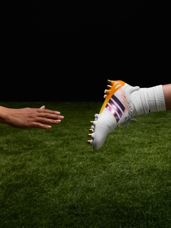 Four images showcasing the new adidas rugby boot range. The first image is an action shot of rugby player Finn Russel diving for a ball on the pitch. He's wearing the adizero RS15 Pro rugby boots in the new colourway. The third image is an action shot of rugby player Ilona Maher running with a ball on the pitch. She's wearing the Avaglide rugby boots in the new colourway.