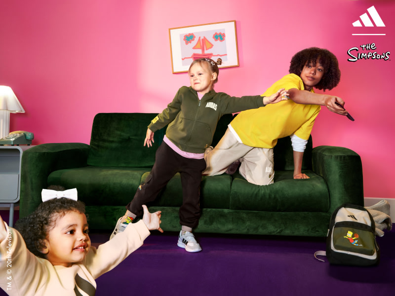 Boy, Girl and small child play in a room with pink walls. All wearing Adidas | The Simpsons collection.