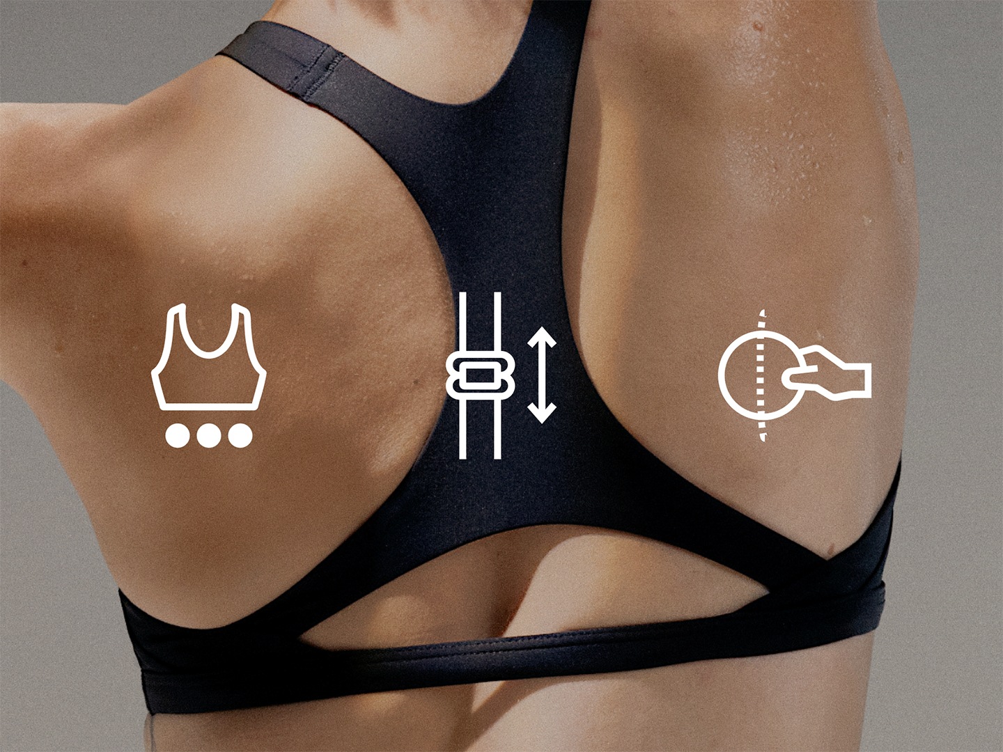 The image shows a person's back wearing a black sports bra or top, with various icons or symbols overlaid on the skin, including a crown-like shape, an arrow, and what appears to be a thermometer or temperature gauge.