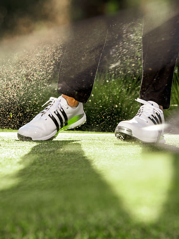 Up close image of men's TOUR360 golf shoes mid swing.