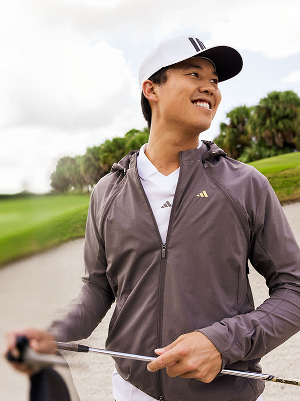 man laughing on golf course