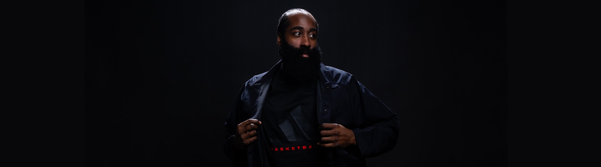 Close-up of James Harden facing camera in dark environment