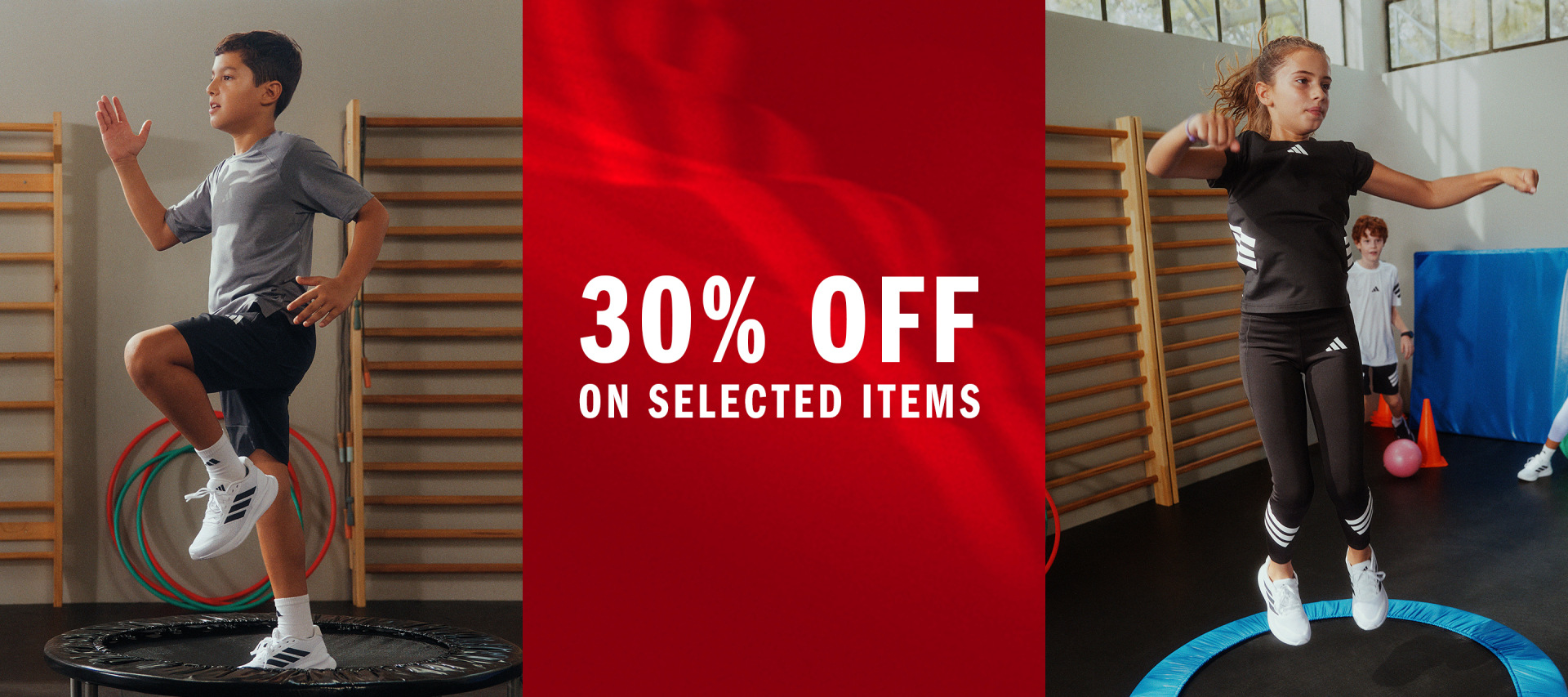 The image shows a red banner advertising a 30% discount on selected items, with two people in athletic wear standing in the background against a wall with exercise equipment.