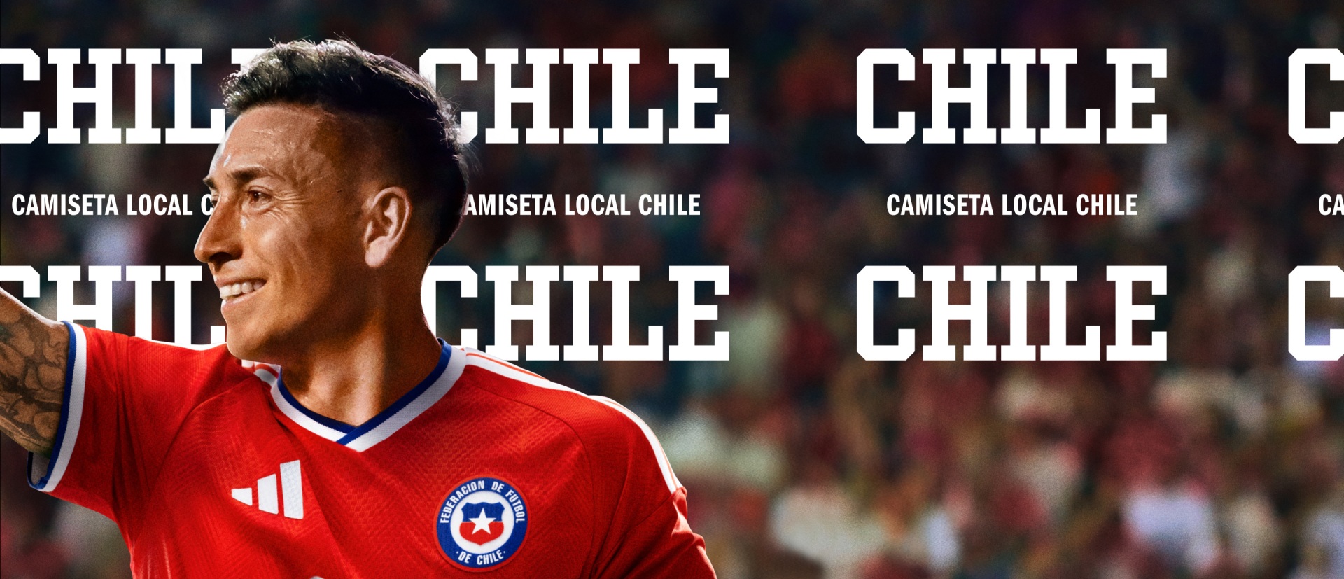 The image shows a man wearing a red soccer jersey with the Chilean national team logo, standing in front of a backdrop featuring the text "CHILE" repeated multiple times.